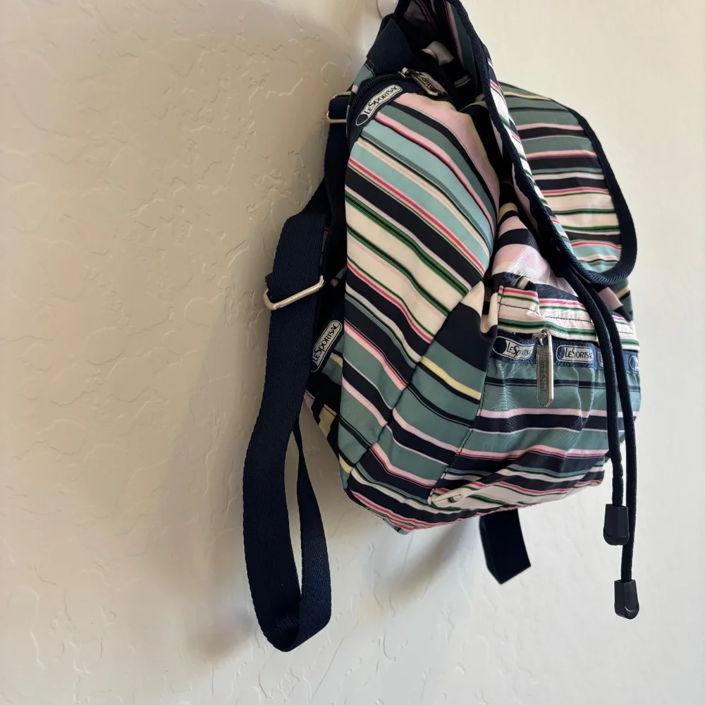 LeSportsac Voyager drawstring backpack in a navy pastel stripe pattern.